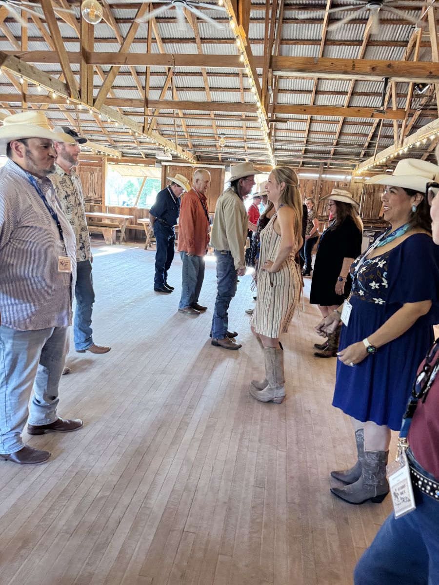 Photo shows a group of people dancing together.
