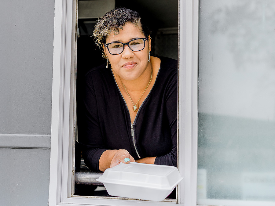 WoodmenLife member Lydia Baher leans out the window of her family's food truck. The whole family helps with the business.