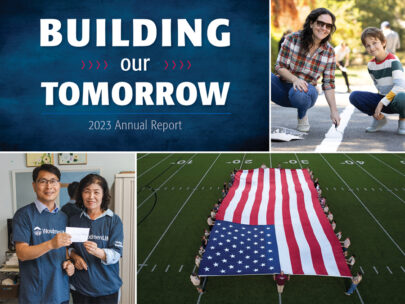 On this image are the words: Building Our Tomorrow, 2023 Annual Report. In addition. there are three photos on this image: one of a woman and child painting a white line on the ground, one of two people wearing WoodmenLife shirts holding a check, and one of an oversized flag display on a football field.