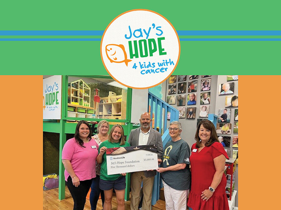 Image includes a photo of a check presentation. there are six people gathered around an oversized check, which is made out to Jay's Hope Foundation in the amount of $5,000. Surrounding the photo is a green, orange and blue border and the Jay's Hope Foundation logo.