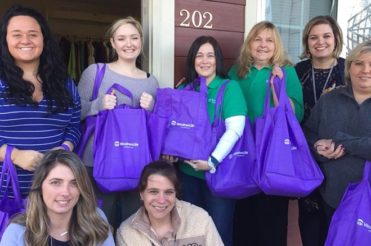 WoodmenLife Chapter 722 members help those in their community with purple bags holding care packages for residents of a spousal abuse shelter in West Liberty, Kentucky.