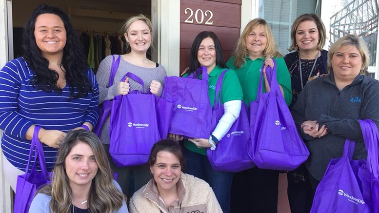 WoodmenLife Chapter 722 members help those in their community with purple bags holding care packages for residents of a spousal abuse shelter in West Liberty, Kentucky.