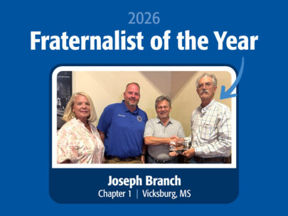 Graphic says "2026 Fraternalist of the Year" across the top, and "Joseph Branch, Chapter 1, Vicksburg, MS" across the bottom. In the middle is a photo of four people, and an arrow is pointing to the man on the far right. He is presenting an award to the man next to him, and they are shaking hands. The background of the graphic is dark blue.