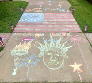 Patriotic chalk art display with the Statue of Liberty