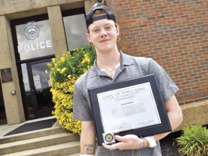 Teen with his award for saving a life