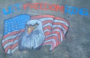 Chalk art of eagle with patriotic message of Let Freedom Ring