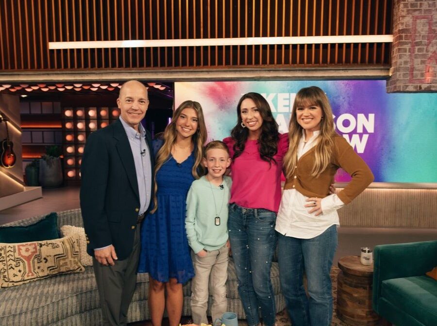 Teenage WoodmenLife member Leighanne Bryant poses for a picture with singer and talk show host Kelly Clarkson, as well as Leighanne's father, Jim, and a mother/son pair, Jennifer and Jack, who benefited from Leighanne's nonprofit, Gold Star Kids Support Services.