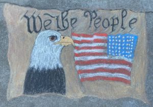 Chalk art of eagle with patriotic message of We the People