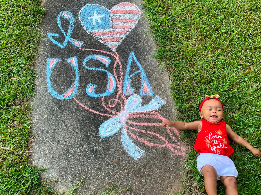 Baby girl with a patriotic chalk art drawing