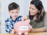 Mom and young son with a piggy bank