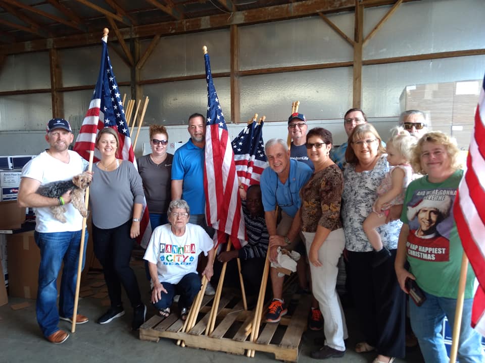 volunteers pictured with flags for Heroes Garden at the Snowball Express